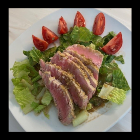 tuna steak on a bed of lettuce 
